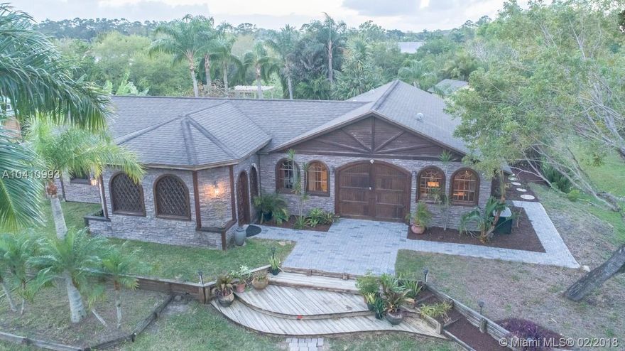 FEEL LIKE A MILLION...You won't see another house that boasts such detail and craftsmanship.  This OUT OF THE FLORIDA HOME BOX offers classic marble floors, is comfortable and sophisticated.  It's a one of kind home. Feels great to be in. Split floor plan, SECOND MASTER SUITE with it's own entrance.  Handsome granite counter tops, double oven, a new refrigerator, stainless steel appliances, an island stove top, pantry, snack bar, entertainment bar, arched windows. Gorgeous double door entry way leading to double doors through to in-ground pool view. Impact windows and pond on 1.25 acres...Gorgeous detailed ceilings, rounded walls.