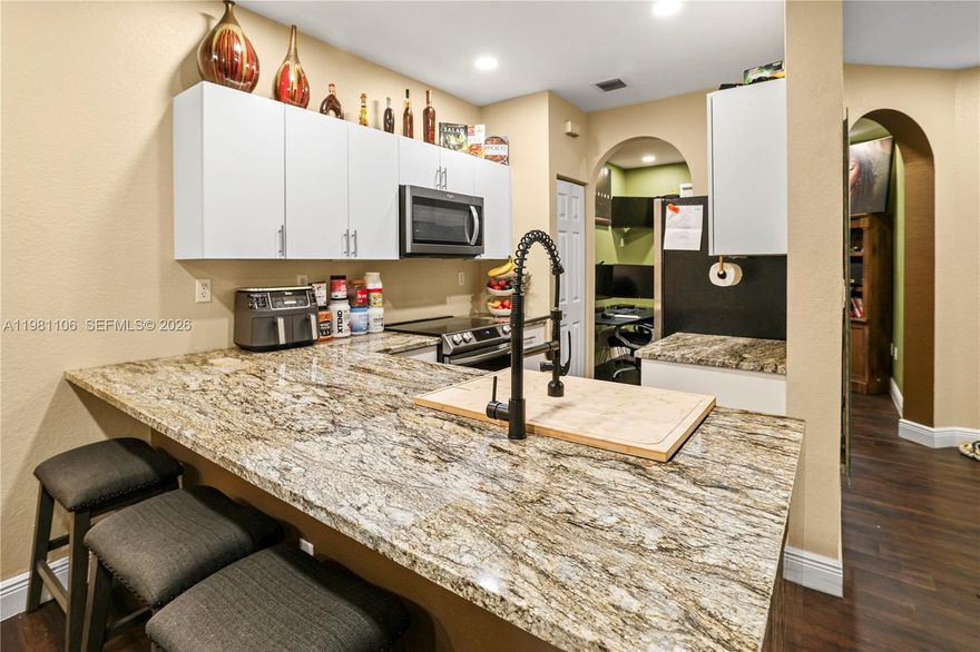 3 bedroom townhouse with beautiful rock wall in family room. Vinyl in all 3 upstairs bedrooms and tile downstairs. Stainless steel appliances and separate dining room. Granite counters, crown molding, ceramic tiles along with modern appliances, such as top loading washer & dryer available in this spacious town home with an extra room that can be used as an office/den/dining room. With a lovely community gym and pool . Well kept association with community pool. Will not last!!!