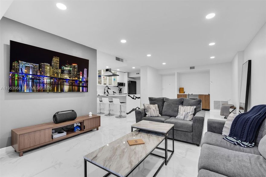 Step into a refined modern residence defined by clean lines, elevated finishes, and effortless sophistication. Expansive open living spaces are wrapped in sleek porcelain flooring, creating a bright, gallery like atmosphere ideal for both entertaining and everyday living. The custom chef’s kitchen anchors the space with striking waterfall countertops, contemporary cabinetry, premium appliances, and a dramatic island designed for both function and statement. The primary suite is a true retreat, featuring generous proportions and a custom walk-in closet designed like a private boutique-complete with built-in shelving, drawer systems, and dedicated space for curated wardrobes and accessories. A spa-inspired bath completes the experience with modern finishes and a glass-enclosed shower. Every detail has been thoughtfully curated to deliver a turn-key, luxury lifestyle with timeless appeal.