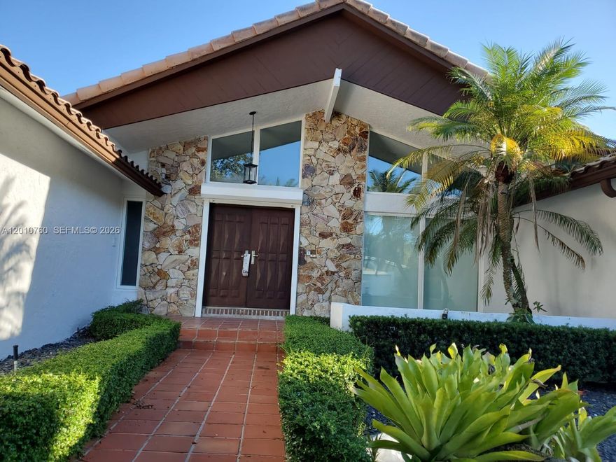 Stunning executive residence nestled in a quiet neighborhood, offering elegance, space, and an abundance of natural light throughout. This impressive home features soaring vaulted ceilings, marble flooring, 7 bedrooms, and 4 bathrooms. Enjoy a well-designed layout with formal living and dining rooms, a spacious family room with a wet bar, and a separate game room—perfect for entertaining. The eat-in kitchen includes a center cooking island and ample space for gatherings. Step outside to a beautiful pool area, ideal for relaxing or hosting guests, along with a circular driveway and hurricane shutters for added convenience and peace of mind.