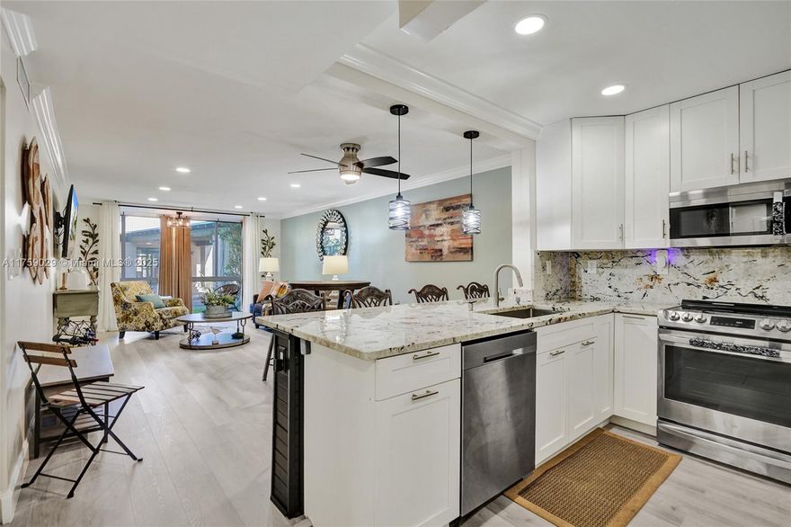 Make this piece of  heaven on earth your home! Nestled on the 1st floor enjoy the peace of ease. This modern yet homey corner unit home is designed for ultimate comfort and style, featuring hurricane-proof windows and doors throughout. Gorgeous wood accents, including tongue and groove details, add warmth and character, while crown molding and recessed lighting elevate the entire space. The gourmet kitchen is a chef's dream, with stainless steel appliances and a beautiful marble island. Enjoy the serene enclosed patio with a Bluetooth audio fan, perfect for  relaxing or entertaining. The updated electrical system, 2018 A/C, and organized closet ensure modern convenience, while ceiling fans in every room provide year-round comfort. 
This home is truly customized for your lifestyle!