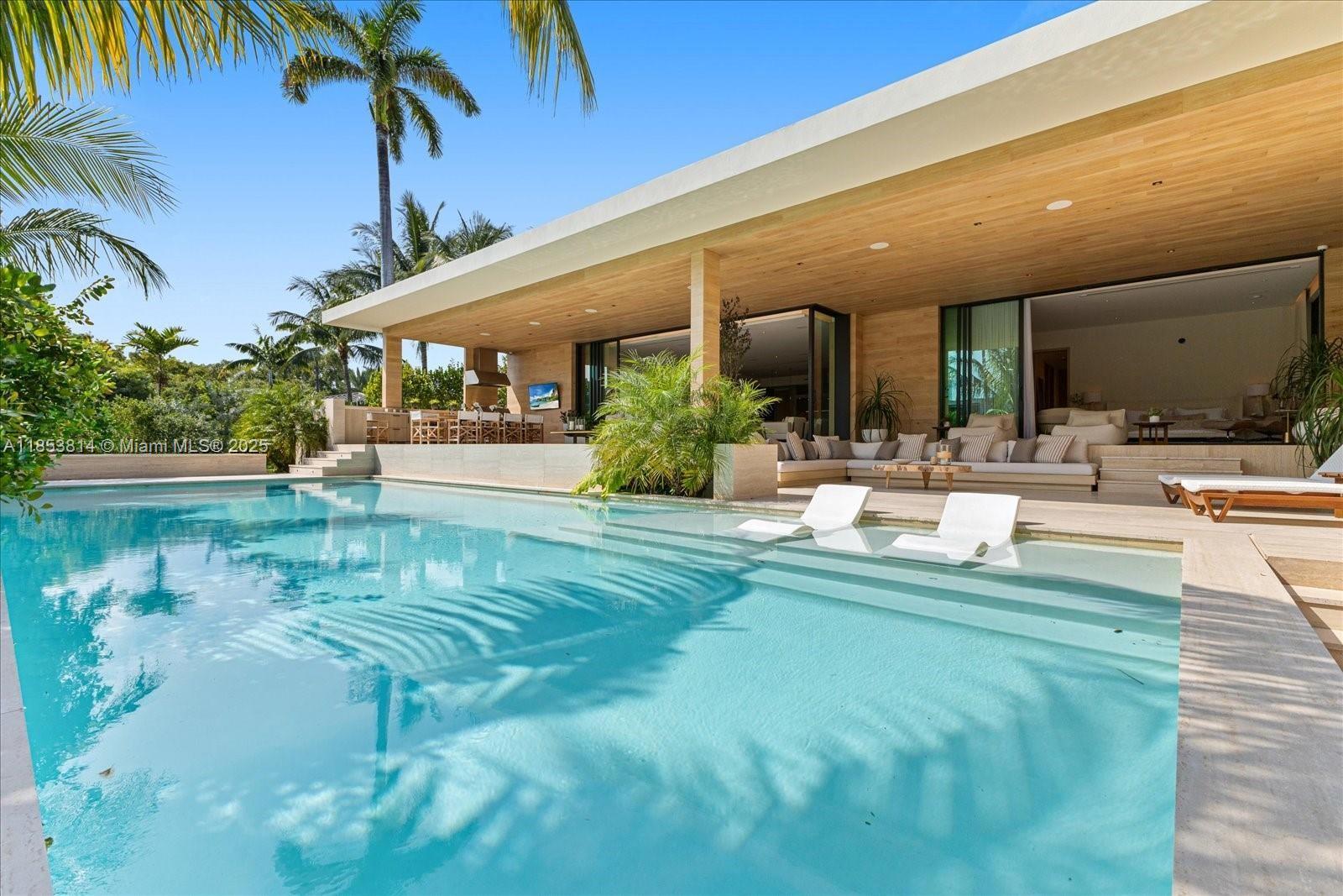 Newly constructed and elevated, this modern waterfront residence offers 9000+ SF of living space with 90 feet of water frontage on coveted, guard-gated Sunset Island III. A perfect home for those who seek both privacy and connection to Miami’s iconic waterfront boating lifestyle, with walkability to Sunset Harbor's restaurants, fitness studios, padel club and waterfront park. Design features include natural materials such as white oak, marble, and travertine to bring warmth and sophistication, while floor-to-ceiling glass and skylights create seamless indoor-outdoor living, custom Italian kitchen with top-of-the-line appliances, a heated pool with all-day southern sun exposure, spa, rooftop loft with terrace, and well-designed outdoor spaces to relax and entertain.