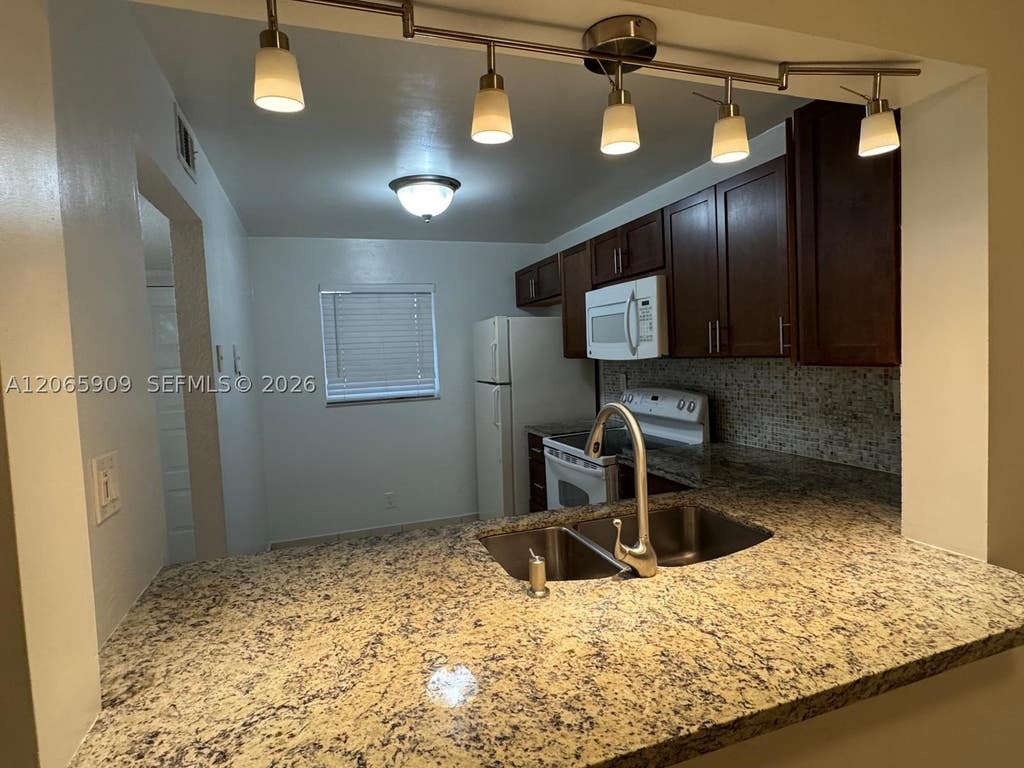 Photo of 3022 Coral Springs Dr #104-3, Coral Springs, FL 33065 (MLS # A12065909)