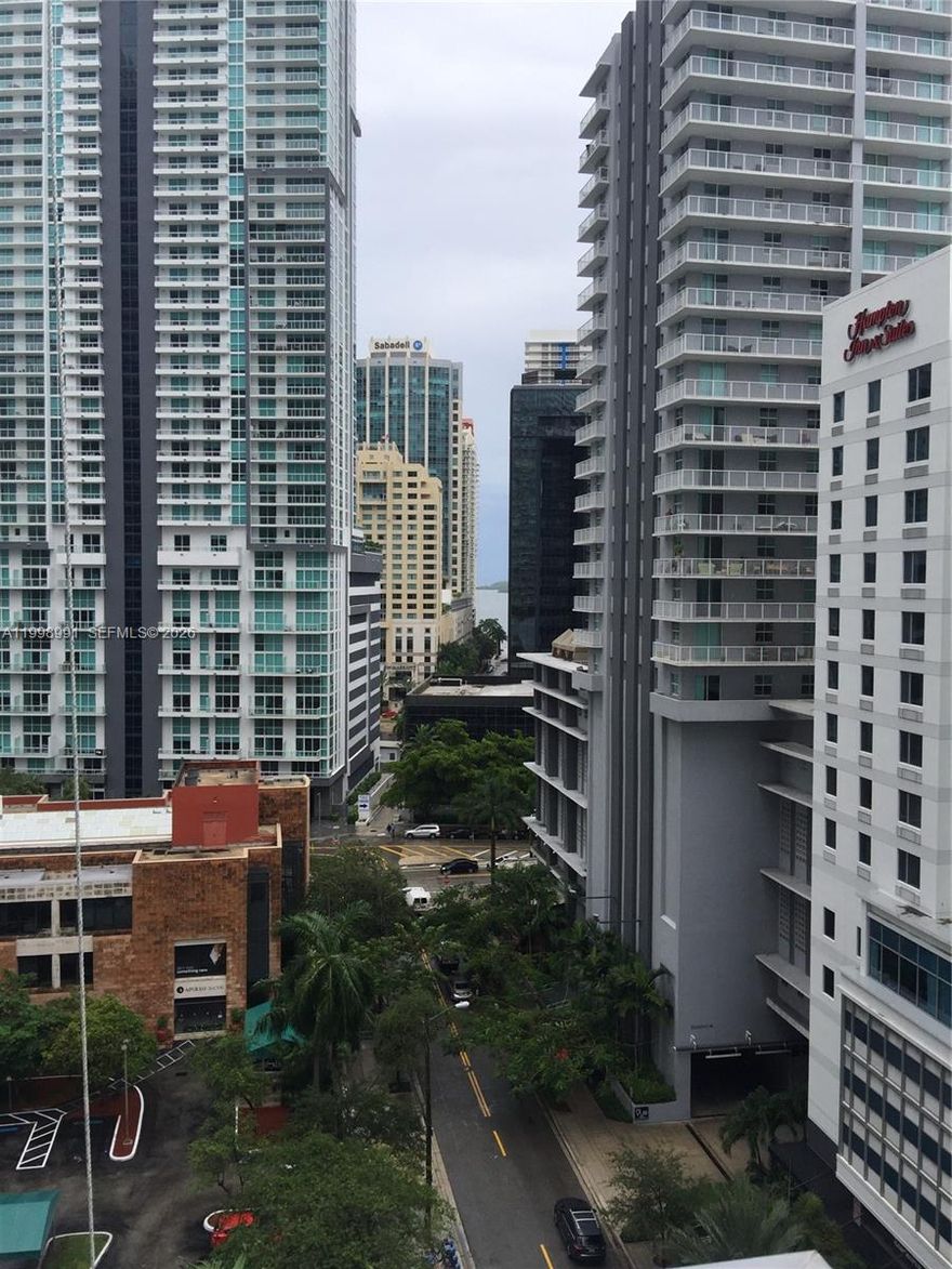 Experience true luxury living in the heart of Brickell with this stunning corner unit featuring 2 bedrooms, 2 baths, and a massive wrap-around balcony showcasing unobstructed, breathtaking city views. This is the best line in the building—beautifully updated with modern wood-look flooring, a sleek kitchen with stainless steel appliances and granite counters, floor-to-ceiling windows, in-unit washer/dryer, plus a spacious split floor plan with a generous primary suite, walk-in closet, and dual-vanity bath. Enjoy resort-style amenities including a state-of-the-art fitness center, sauna, two pools, hot tub, business center, and 24/7 security. Perfectly located just steps from Mary Brickell Village, City Centre, top dining, grocery stores, and the Metrorail station. New refrigerator, A/C unit, and water heater add exceptional value. Monthly rentals allowed (verify HOA), making this a high-flexibility investment—currently rented at $4,000 until Dec 31, 2026. Priced to sell!