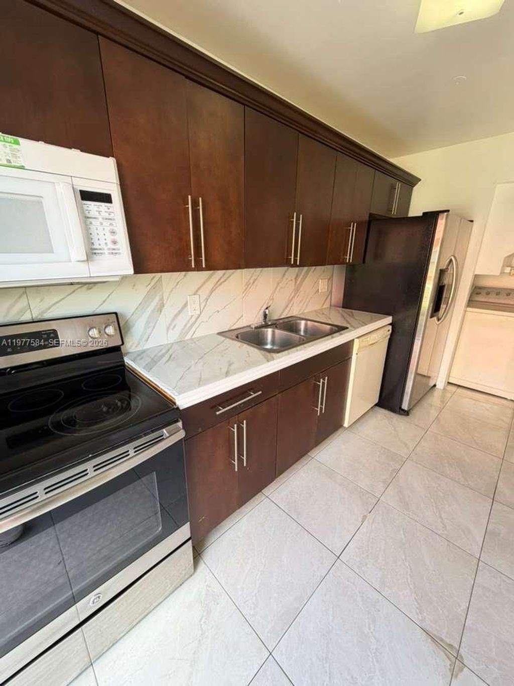 Photo of 2462 NW 52nd Ave #2462, Lauderhill, FL 33313 (MLS # A11977584)