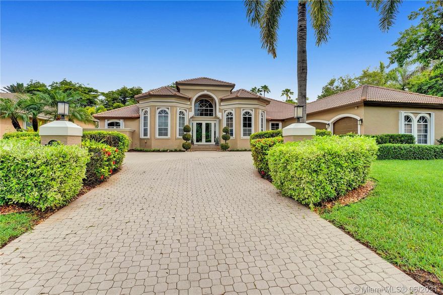 This is the home you have been waiting for! STUNNING and meticulously maintained 5 bedroom, 3 1/2 bath home PLUS office/den and playroom/billiard room with wet bar. Perfectly located in the Provence neighborhood of Weston Hills Country Club with a NEW roof. Numerous features include: fantastic triple split floor plan, volume ceilings with beautiful crown moldings, master bedroom suite with dressing area, large walk-in closets & luxurious bath, formal living & dining rooms, butler's pantry, gorgeous kitchen with center island, wood cabinets, granite countertops & large pantry, family room with wood built-ins & desk area, covered patio, private and charming back yard with NEW pool & spa - all together with a spacious backyard, 3 car garage and accordion hurricane shutters!