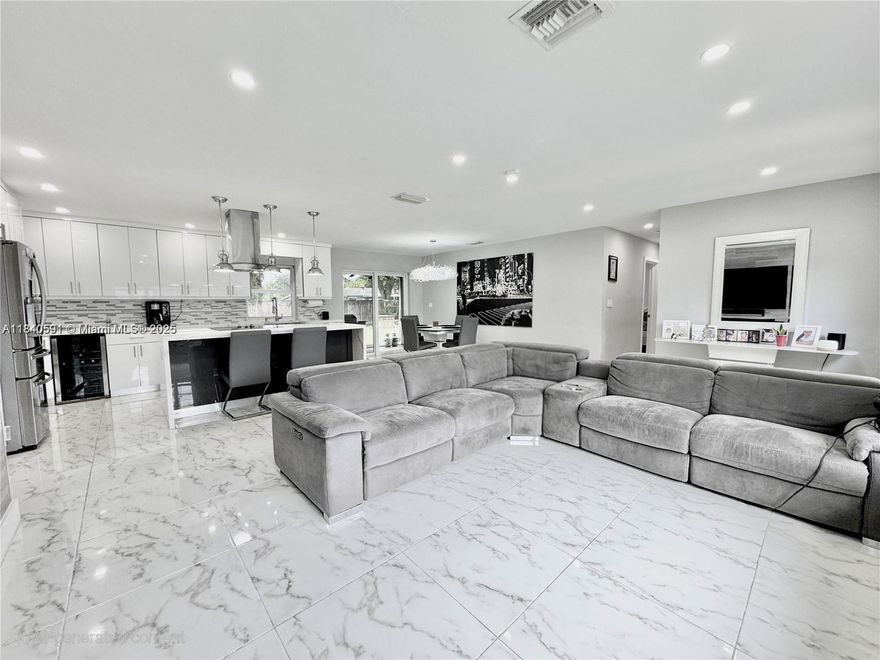 NO HOA! Beautiful 3/2 home with a 2-car garage on a quiet street in Plantation. Stunning open-concept kitchen with custom wood cabinets, Calacatta quartz counters with waterfall & island, backsplash, under-cabinet lighting, stainless steel appliances. Modern bathrooms w/ glass showers & floating vanities. New tile floors and baseboards. Spacious bedroom with walk-in closets. Upgraded garage door rated for 200 mph. Huge fenced yard with room for a pool, screened patio, well irrigation, and LED lighting. The backup gas generator runs automatically and is permanently connected to the panel via a transfer switch. Park your RV, boat, or jet ski! Fall in love!