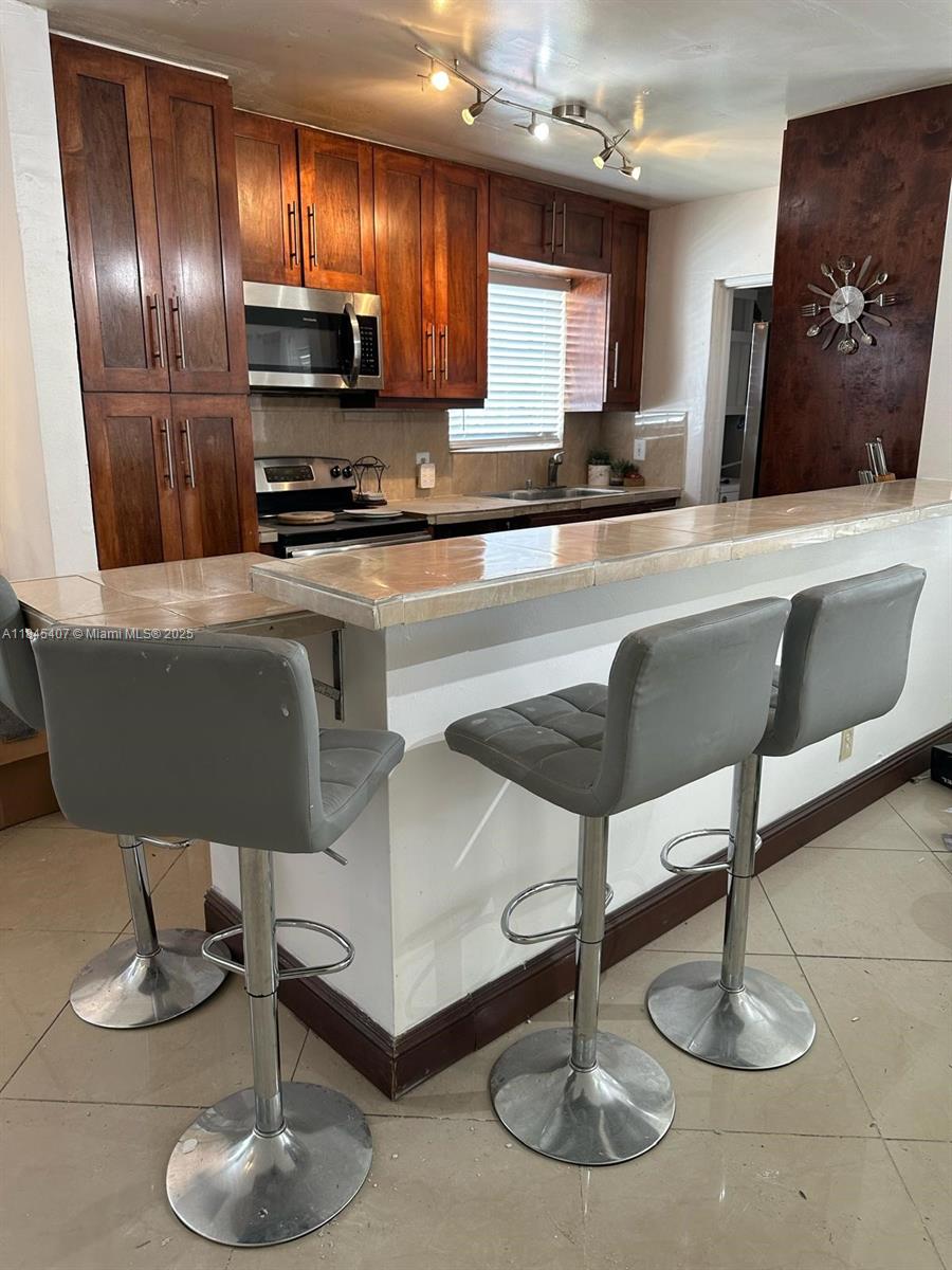 Section 8 Welcome! - Modern and quiet single family home for rent in sunny Hallandale Beach! 4 bedrooms, 2 bathrooms + den, laundry room, private backyard and spacious front yard/driveway and covered car port. High-end tile throughout plus modern custom kitchen. Do not contact listing agent, refer to Broker Remarks. **Proof of Income required + First and Last Month + Security Deposit to move in.**