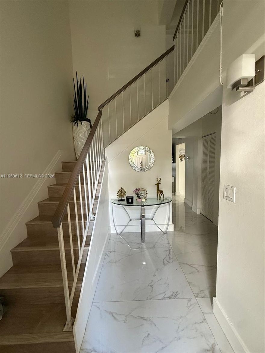 Welcome to this beautifully remodeled 3-bedroom, 3-bathroom residence located in a desirable gated community with serene lake views. This move-in-ready home features modern finishes throughout, an open and airy layout, and a covered terrace overlooking the lake—perfect for relaxing or entertaining year-round. The gated community adds security and includes a clean, spacious pool, perfect for entertaining. You’ll have two assigned parking spots conveniently close to your front door, plus additional guest parking. Situated in a highly sought-after school district, this home is ideal for families. Enjoy tranquil waterfront living while remaining close to shopping, dining, and major roadways. Don’t forget the spectacular sunsets that make this property truly special. This is a rare opportunity to own a turnkey home in a highly sought-after neighborhood. Schedule your private showing today!