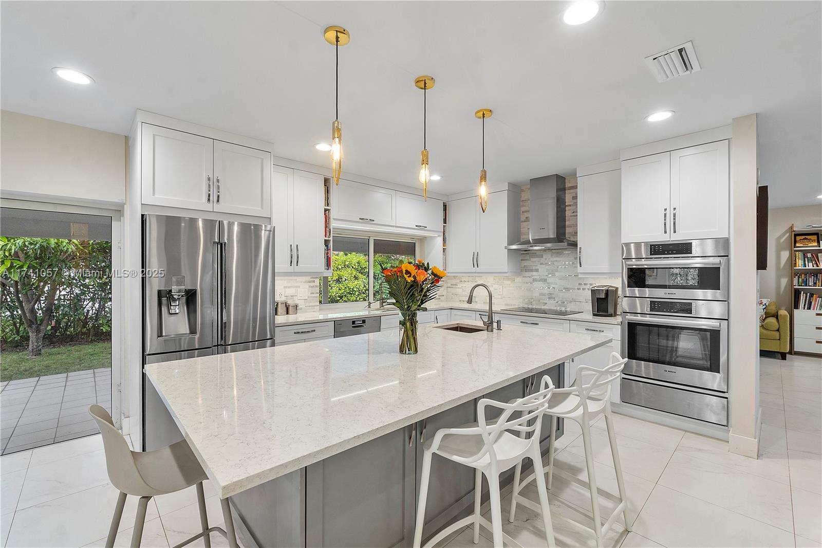 Spacious, bright, and renovated 4-bedroom, 3-bathroom home in a prestigious South Gables neighborhood. Walking distance to Jaycee Park, the Thesis Hotel, the University of Miami, and the Metrorail. The home features a gourmet kitchen with quartz countertops, top-of-the-line stainless steel appliances, an oversized island, pantry, wine cooler, and bar area perfect for gatherings and entertaining. Completely updated electrical and plumbing, porcelain floors, and impact windows. Solar panels and Tesla powerwall provide low electric bills and full-house backup power. A maid's quarters, ample storage, a garage, a large screened patio, and a lush fenced-in yard with mango trees, round out the impressive list of features. Great schools nearby. This is the home you have been waiting for!