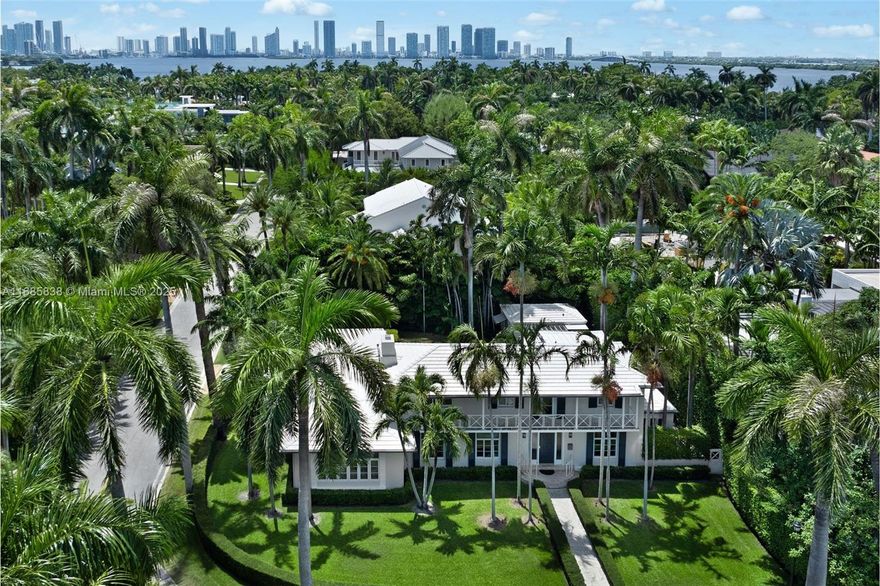 This iconic Palm Beach-inspired Colonial 4-bed/4-bath estate by renowned architect Russell Pancoast, occupies a prime corner lot on coveted Sunset Island II. Inside, discover a world of timeless elegance: terrazzo floors, Art Deco flourishes, and a grand curved staircase. The gourmet kitchen with top-of-the-line appliances has a striking marble island, cozy breakfast nook, and adjacent prep area, effortlessly opening to a generous TV lounge and office alcove. Upstairs, the sunlit primary suite offers a serene retreat overlooking the gardens. Outside, a coral stone-framed pool, spacious patio, and charming cabana house create a private oasis. Located near Sunset Harbour, this impressive residence features a two-car garage and dual entrances, offering a blend of practicality and elegance.