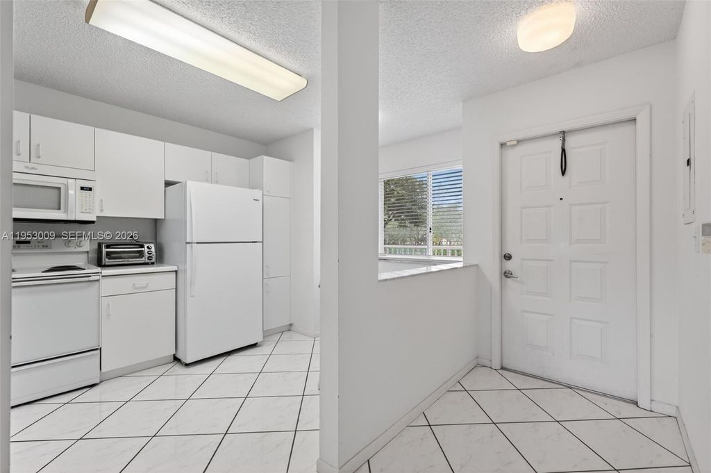 Photo of 9525 Weldon Cir #H205, Tamarac, FL 33321 (MLS # A11953009)