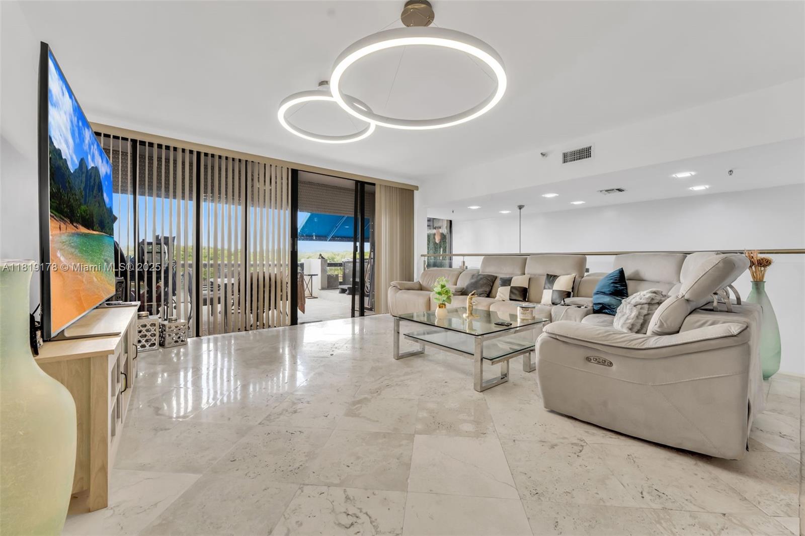 Waterfront Living on Poinciana Island. Live the resort lifestyle in this rarely available 3-bed, 2.5-bath two-level condo on the exclusive, guard-gated Poinciana Island in Sunny Isles Beach. Surrounded by water, this private island offers scenic walking paths around the entire dock, 24/7 security, and two tennis courts just steps from your door. Enjoy expansive Intracoastal and park views from your private terraces. The home features high ceilings, an open layout, modern finishes, and a large kitchen perfect for hosting. The primary suite includes an en suite spa bath, while the spacious split-level floor plan adds privacy and versatility. Located minutes from the beach, Bal Harbour, and Aventura, this is your chance to own a piece of paradise.