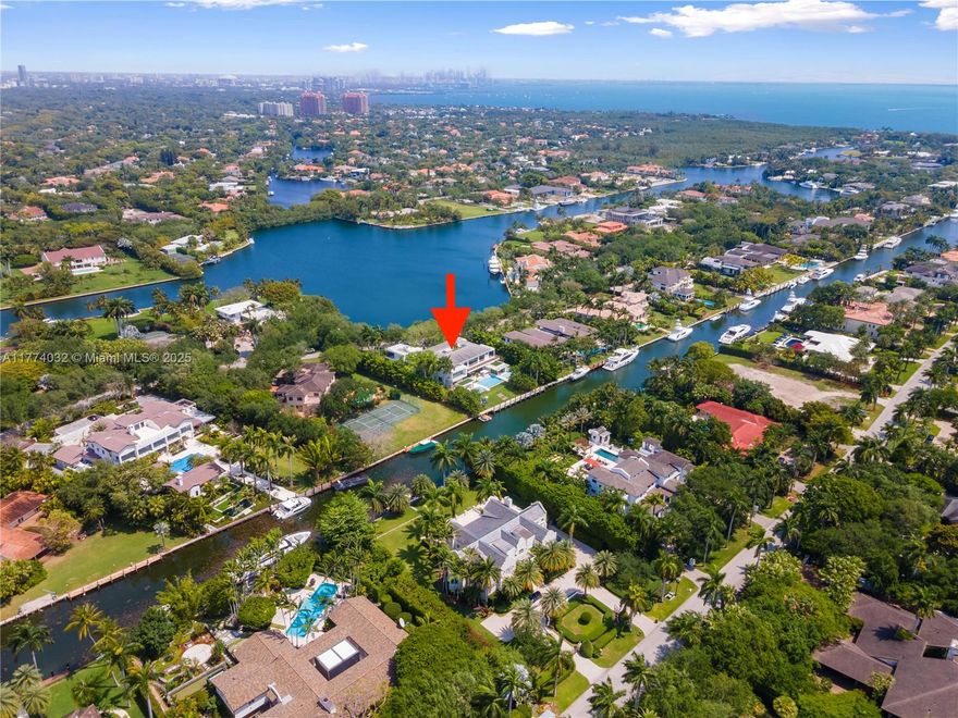 2018 built and designed modern Marvel by Hugo Mijares, Corradi Group in conjunction with Lucrecia Lindemann Luxury...Located in the one and only coveted "Gables Estates". Water view on both sides of estate. Boasts 12,292 interior space on a acre plus lot. No detail spared. 8 Bd/ 7 Bth 1 Half bath 12,437 SqFt Liv Area,15,073 Adj Area SF,4 car garage 42k sqft Lot with water on both sides. NE Exposure. A natural curtain of lush tropical trees surrounds the site, while its slightly slopping terrain offering an ideal location for the house itself inbetween a canal and a open bay .Retractable glass panels on the pool-facing side dramatically open up the house to the outside, while also being mindful of the need for privacy.Series of Courtyards brings light & vegetation inside the Estate.