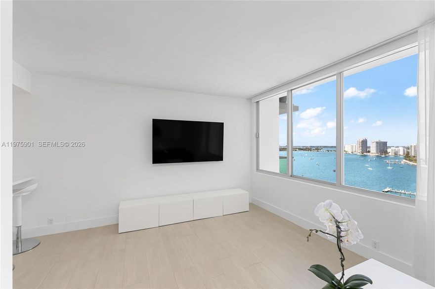 Incredible renovation of this high floor residence w/ soaring Riviera like views of Biscayne Bay! No expense spared in this immaculate furnhised home that includes a great layout with a gleaming open kitchen, separated bedroom area with en-suite bath and plenty of light. This full service bayfront building just completed a total transformation and offers an amazing new resort style pool & amenity deck w/ grill, jacuzzi and marina, very large Fitness Center on-site convenience store, spa & hair salon. Perfect central location walking distance to shopping, dining, Lincoln Road, beach plus easy access to causeway and all major highways and MIA! Cable/Internet Included