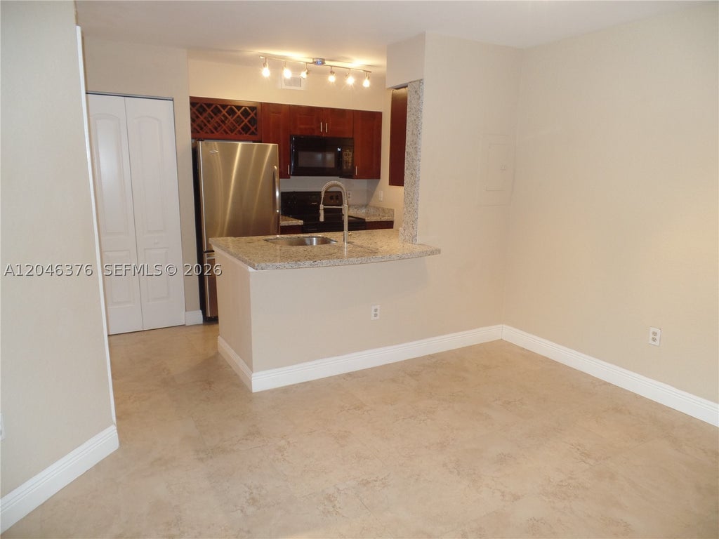 Photo of 2811 N Oakland Forest Dr #205, Oakland Park, FL 33309 (MLS # A12046376)