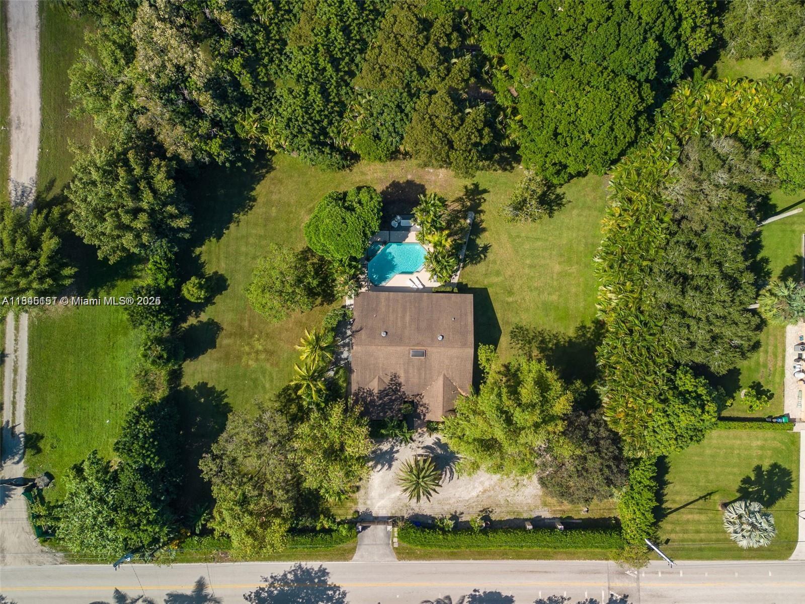 Step into your own gated sanctuary on 1.25 lush acres in prestigious SW Ranches. This tropical estate blends privacy, scale, and endless potential. Three separate entrances offer space for guest houses, pickleball, or equestrian living. Inside, dramatic ceilings and expansive open spaces set a grand tone, with a garage conversion adding total sq ft to 3059 creating a spacious 4th bedroom. Mature, curated landscaping surrounds a resort-style pool. Zoned for horses and nurseries, with room to build your dream compound. The rectangular layout, privacy, and serene setting make this a true hidden gem. Minutes from elite shopping, dining, and highways—yet it feels a world away. A rare opportunity to own a home that lives like a private resort—bold, beautiful, and unforgettable.