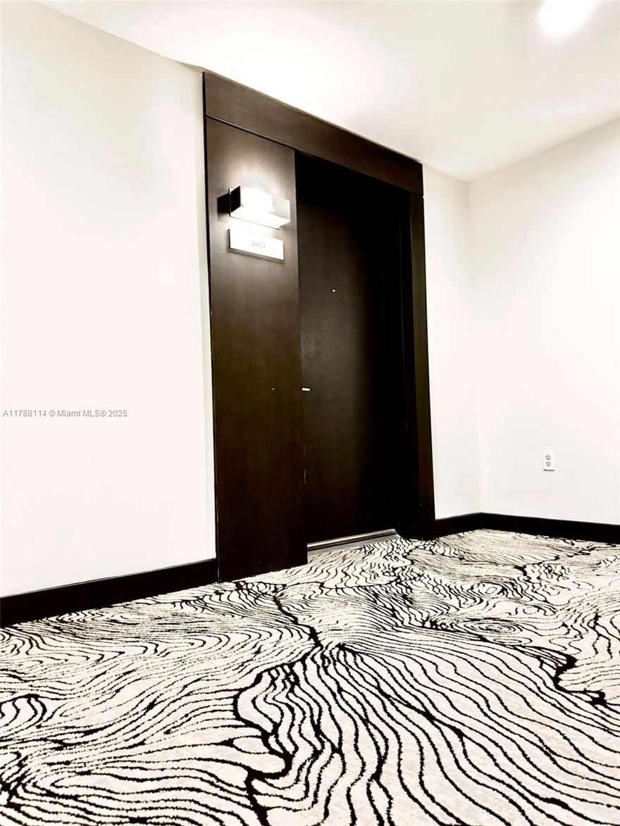 Elevated above Miami’s coastline, this 1-bed 2-baths residence at 900 Biscayne delivers panoramic views of the Southeast shores and Key Biscayne. High ceilings and a spacious balcony set the tone for luxe living. The gourmet kitchen features premium appliances and a custom eat-in island. The primary bath boasts onyx walls, dual sinks, enclosed shower, and a spa tub. High-impact windows, blackout shades, generous closet space, and a laundry room complete the home. Enjoy resort pools, fitness center, and concierge service—steps from Miami World Center and minutes from Design District, Wynwood, Brickell, and the beach.