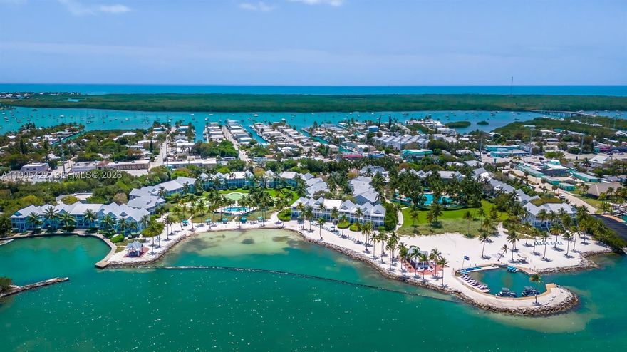 Introducing an exquisite POOLSIDE retreat at Tranquility Bay Beachfront Resort in the heart of the Florida Keys--a pinnacle of refined island sophistication and world-class amenities. This impeccable two-story townhome is mere steps from the resort's magnificent lagoon-style swimming pool, an adults-only pool, a tropical garden pool, and a pristine 2.5-acre private WHITE SANDY BEACH with uninterrupted Gulf of Mexico vistas. These unparalleled waterfront and leisure features establish an unmatched standard in the region near the 7 MILE BRIDGE. Tranquility Bay is renowned for its exceptional, meticulously MANAGED RESORT experience, ideal for discerning families and couples seeking an elevated getaway. Indulge in a state-of-the-art fitness center, a signature Jack Nicklaus Golden Bear putting green, complimentary kayaks and motorized watercraft rentals, volleyball courts, and rejuvenating in-suite spa services. Savor GOURMET DINING at the acclaimed Butterfly Café with ocean-fresh seafood and island-inspired cuisine, or unwind at the beachfront TJ's Tiki Bar, where crafted cocktails, live music, and casual Caribbean fare complement the ocean breeze. Unit #22 exemplifies meticulous care and coastal elegance, featuring three generously appointed bedrooms with soaring cathedral ceilings and two full bathrooms upstairs, plus a convenient half bath downstairs. Expansive white balconies and spacious patios serve as private sanctuaries for al fresco relaxation and breathtaking sunsets.