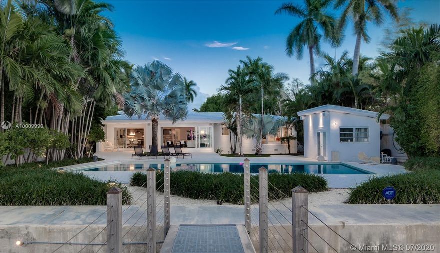 LAND VALUE! The lowest priced waterfront on prestigious North Bay Road! Situated on a 19,685-SF lot with 75 feet of wide waterfrontage on the most prestigious Miami Beach address, this lushly landscaped waterfront property is completely secluded with high hedges for extra privacy and security. The current house is a fabulously modernized mid-century modern featuring an open-concept floor plan with floor-to-ceiling impact doors and windows, terrazzo floors, updated kitchen with a wet bar, large master suite, new roof, and more. The expansive backyard features a pool and offers incredible water and sunset views! The property has a new seawall and dock.