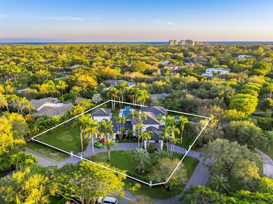 An extraordinary opportunity in Pinecrest, one of South Florida’s most prestigious neighborhoods. This fully renovated estate defines modern luxury, offering over 7,778 square feet of designed living spaces with vaulted ceilings, 7 bedrooms, 8 bathrooms, beautifully polished marble floors, updated bathrooms with Grohe finishes, and a 2 and half car garage. The gourmet kitchen features Thermador appliances, bespoke cabinetry, and quartz counter tops. Enhancing the estate is a beautifully appointed detached guest house offering 3 bedrooms and 3 bathrooms—ideal for hosting or an in-laws quarter. The outdoor experience features a resort-style oasis with a sparkling pool, summer kitchen, expansive entertaining terraces, and a private pickle ball court, all surrounded by lush landscaping. Set on a builder’s acre, this gated corner lot offers added privacy and security. Located in a top-tier school district. A must see, Schedule your private tour today.