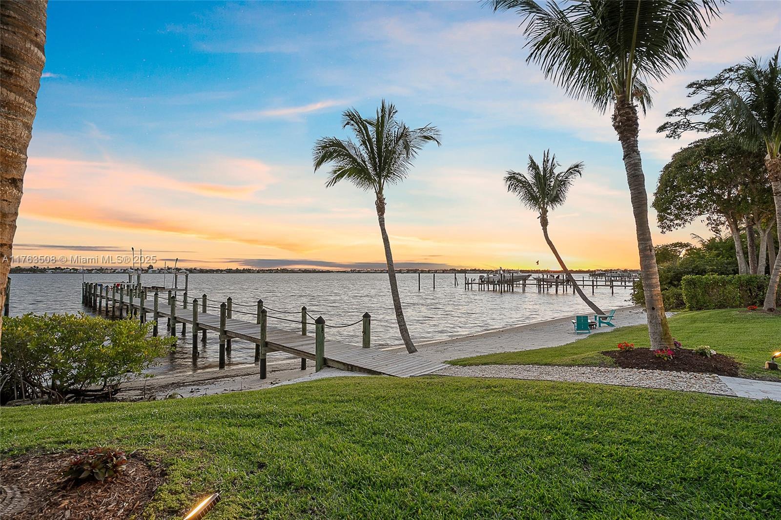 Experience true waterfront luxury in this 2017 custom estate, now offered at a new reduced price. Privately set behind gates on nearly an acre, the residence was designed to capture sweeping views of the St. Lucie River while blending comfort, elegance, and sophistication. Inside, you'll find six spacious bedrooms, two private offices, 4.5 baths, a 4.5-car garage, and a versatile guest or in-law suite. Soaring ceilings, a sleek metal roof, and seamless indoor-outdoor flow showcase Florida's signature style. Outdoors, enjoy resort-level living with a spectacular infinity-edge saltwater pool, spa, sun shelf, fully equipped summer kitchen, generator, and your own private sandy beach. Nearly 115 feet of pristine waterfront with a deep-water dock and 20,000-pound lift accommodates yacht