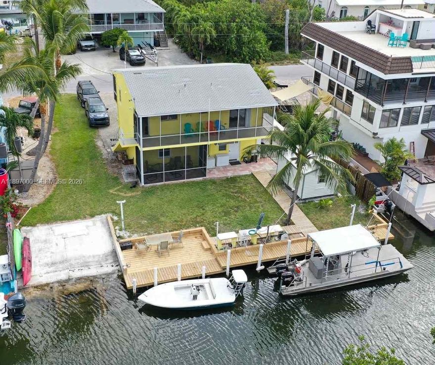 Boater’s dream home in White Marlin Beach, Islamorada. Unique 2-story single-family home with split layout, two 800 square feet 2BD/1BA units. Separate entrances and laundry in each unit, 70' dock with private boat ramp on a tranquil mangrove canal. This property is facing mangrove with maximum privacy, just 7 homes from the bay! Plenty of parking for RVs/trailers. Enjoy access to the White Marlin’s private homeowners park and beach, one of the only white sand beaches for miles. Perfect for extended family, guests and rental income potential. Don’t miss this rare opportunity in one of the Keys most sought-after neighborhoods.