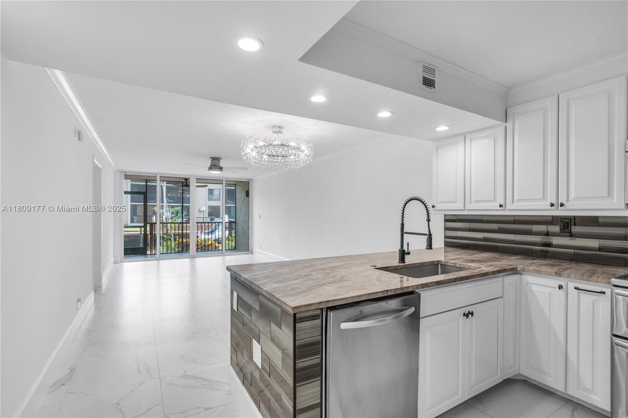 Enjoy modern waterfront living in this fully renovated 2-bedroom, 2 bathroom condo located in the heart of East Boca Raton. This first-floor unit features a private patio with serene water views and direct access to a dock -- available for rent -- perfect for boating enthusiasts or those who love the coastal lifestyle. 
Inside the condo boasts a modern open layout with brand-new flooring, a sleek kitchen with marble countertops and stainless steel appliances, and two beautifully updated bathrooms. Each spacious bedroom is an en-suite, offering full private bathrooms and generous closet space. The ground-floor location provides easy access and a private, home-like feel while being just minutes from Boca's best beaches, shopping, dining and entertainment.