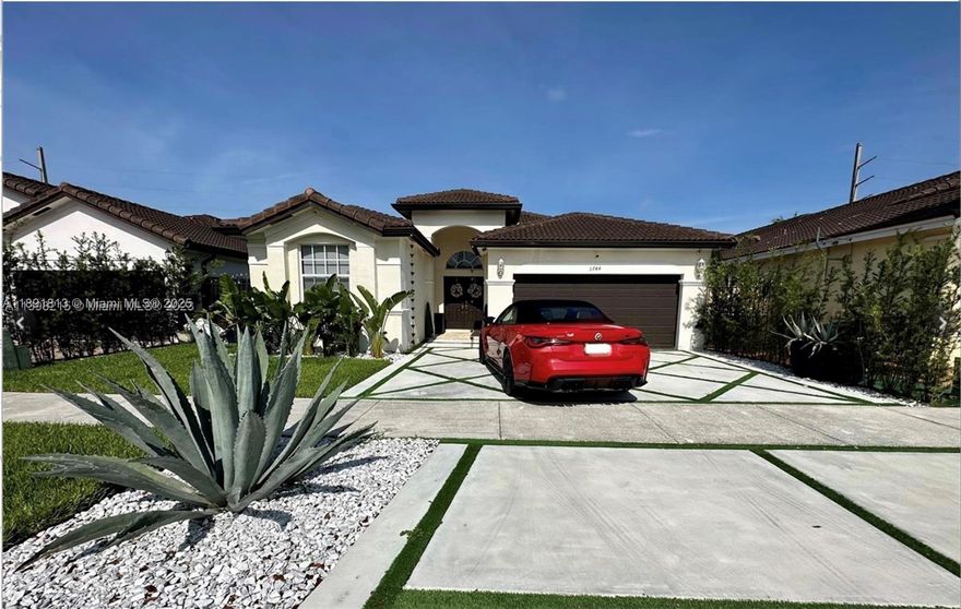 Welcome to this stunning and impeccably maintained residence in the heart of West Kendall! This beautifully updated 3-bedroom, 2-bath home features soaring high ceilings and a bright, open floor plan filled with natural light. The home has new 32x32 porcelain tile flooring throughout, offering a sleek and modern feel. The primary and recently renovated backyard and driveway. New hurricane impact doors & windows. The side yard is fitted with premium turf & added padding underneath, creating a safe & fun play area for children. New modern driveway with artificial turf inlays adds a unique architectural touch and curb appeal. Additional features include a 2-car garage, lush privacy hedges, and a quiet, family-friendly neighborhood close to top schools, shopping, and dining.