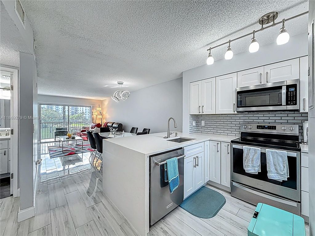 Photo of 2228 N Cypress Bend Dr #303, Pompano Beach, FL 33069 (MLS # A11869279)