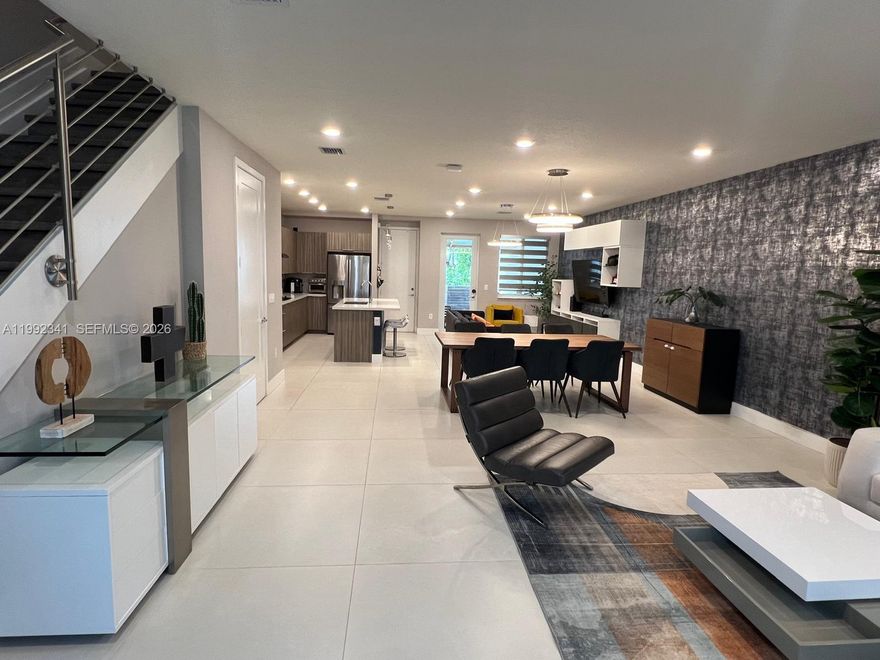 Modern two-story townhouse offering 3 bedrooms and 2.5 bathrooms, thoughtfully designed for both comfort and style. This residence features a bright and functional layout, enhanced by tasteful modern wall décor in the living area, adding a unique and contemporary touch. The home is also equipped with a smart home system, providing added convenience, security, and efficiency. The first level showcases sleek tile flooring, while the second floor features durable vinyl laminate throughout.
The kitchen is elegantly appointed with stainless steel appliances and sophisticated marble countertops, making it perfect for both everyday living and entertaining.
Located in the highly desirable community of Doral, residents enjoy convenient access to top-rated schools, shopping centers, dining, and major roadways. The property includes a one-car garage, along with additional driveway parking for two vehicles.
The community enhances your lifestyle with resort-style amenities, including a clubhouse, fitness center, swimming pool, tennis courts, and a dedicated barbecue area—ideal for relaxing or gathering with family and friends.