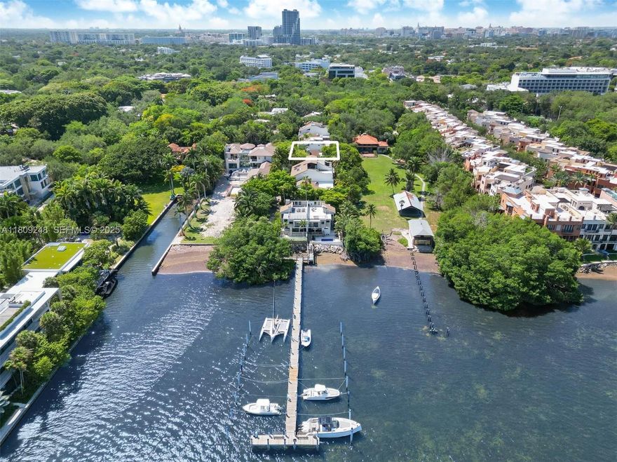 Rarely available townhome in Abitare with private dock access! Nestled in one of Coconut Grove’s most coveted waterfront communities, this 2-bedroom, 2.5-bathroom home offers a unique blend of privacy, nature, and boater-friendly living. Featuring soaring ceilings, an open, airy floor plan, and surrounded by lush tropical landscaping, the home provides a tranquil, secluded feel. Ideally located adjacent to The Barnacle Historic State Park, enjoy the rare luxury of no rear neighbors—just serene, protected greenery as your backdrop. Positioned next to the pool and only steps from the 35’ x 25’ boat slips, this residence is a dream for boaters and outdoor enthusiasts. Live in a 24/7 guard-gated community, just a short stroll to world-class dining, cafés, boutiques, and bayfront parks.