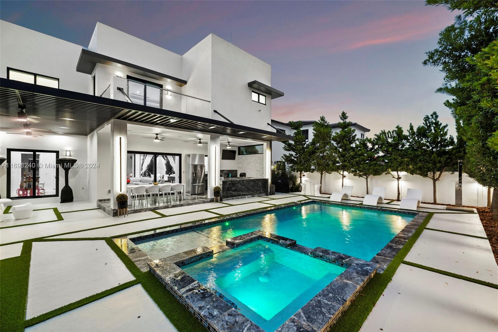 Experience luxurious living just minutes from the University of Miami, Merrick Park, and 15 minutes from Miami Airport.
This tropical modern residence features an impeccable open-concept design, a European-style kitchen, and upscale finishes, including marble flooring throughout. Enjoy in-ceiling speakers both indoors and on the outdoor terrace. The private backyard oasis boasts a Saltwater pool, heated spa, and a fully equipped outdoor kitchen with aluminum cabinetry. For ultimate privacy, the property is enclosed with a 6' CBS wall, aluminum fencing, and a motorized gate. Not to mention LED lighting, 2 A/C system, 12 and 10 foot ceiling with 20' foot ceiling in living room and a Wood Fired Pizza Oven Outdoor!! This house is amazing!
A perfect blend of luxury, comfort, and convenience.