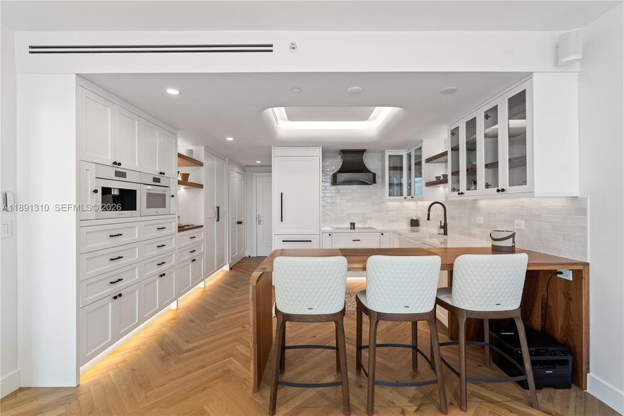 One-of-a-kind, stunning, never-lived-in residence at the Ritz-Carlton Executive Residences, Coconut Grove. Fully reimagined in 2024 by Italian design-builder Mauro Burgio, this spectacular home showcases Italian oak herringbone floors, softly curved wall corners, and custom finishes throughout. The gourmet kitchen features Miele appliances, solid wood cabinetry, a custom walnut table, and a handcrafted copper hood. Elegant lighting includes cove, recessed, and under-cabinet illumination. The spa-like primary bath offers a Hastings soaking tub and walnut vanity. Includes Sonos sound, automated window treatments, thermostat, new high-efficiency HVAC, and LG washer/dryer. A truly rare offering there is nothing comparable on the Miami market today.