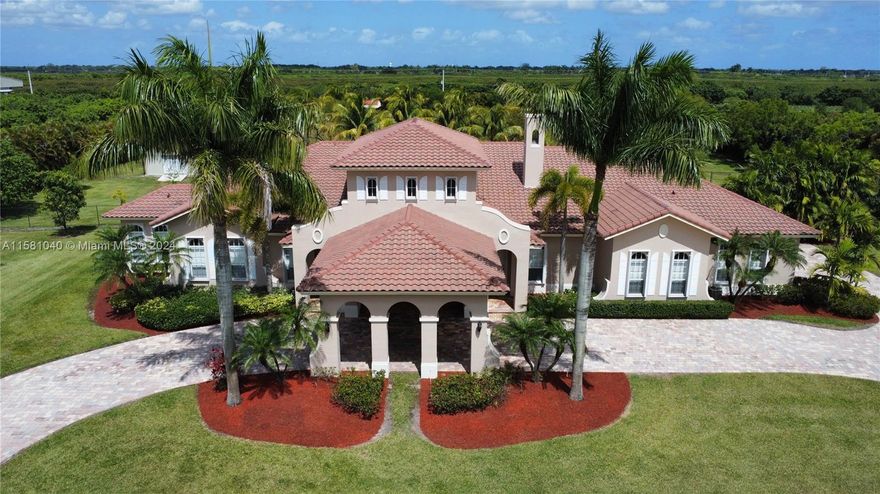 Welcome to your own piece of paradise located on 5 acres of beautiful countryside in the Redlands, completely surrounded by majestic areca palm trees that sets this property apart in a blend of luxury and rural charm. From the moment you enter this property you truly leave the world behind. House exterior freshly painted. Porte cochere and an oversized 3 car garage w/separate A/C unit. Propane gas generator, Tiki hut (34'x38'); outdoor building measures 24'x36' fully insulated, steel pole barn built 2024 approx.28'x50' including porch. Close to Florida Keys, Everglades National Park and other major attractions. Enjoy the many fruit trees this property has to offer. No better place to have picnic outings, stargazing and pool get togethers with family and friends. Come and make it your own.