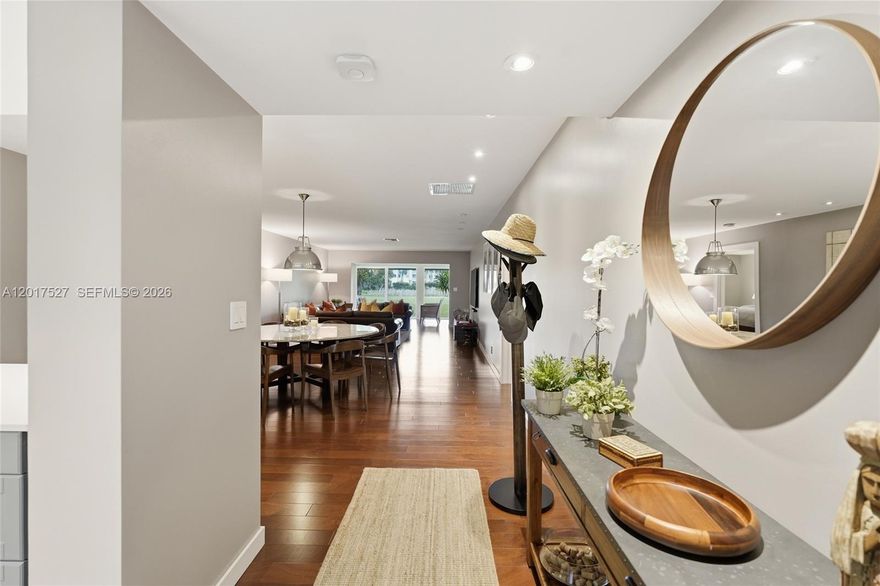Rarely available Patio floor plan — one of the most coveted layouts in the community and seldom on the market. This gut-renovated residence was finished in 2017 and has been transformed top to bottom with designer finishes and nothing left to do.
Rich hardwood floors flow throughout the open great room, dining area, and expansive living room, all bathed in natural light from floor-to-ceiling sliding glass doors overlooking lush green views. The reimagined kitchen features custom grey shaker cabinetry, quartz countertops, glass-front uppers, stainless Samsung appliances, under-cabinet lighting, and a breakfast bar — a chef's kitchen that doesn't sacrifice style for function.
The primary suite is a true retreat, complete with plantation shutters, a spa-caliber bath with dual vanities, freestanding soaking tub, glass-enclosed rain shower, and a custom walk-in closet with full built-ins. Every detail was executed with intention — recessed lighting, designer fixtures, and a curated neutral palette throughout.
Properties at this level of finish in the Patio configuration simply don't come along often.
