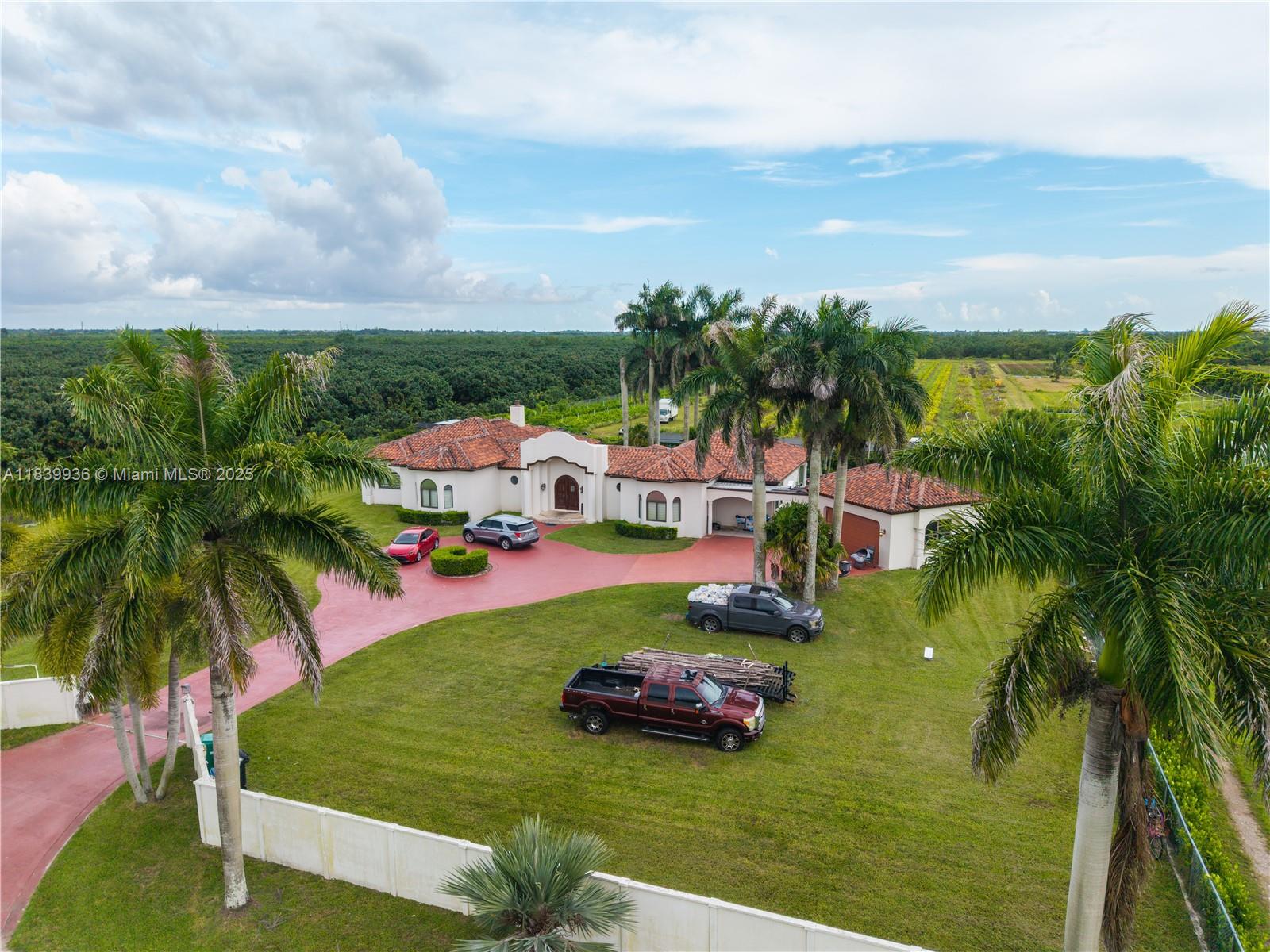 The is a great gross ten acre estate home(9.59 acres net). Built like a bunker in 2007, with plenty of space to expand and develop. The home sits on a large lot that backs up into the c103 canal.
The house need cosmetic remodeling to bring it up to modern standards.
Large detached garage is connected by covered walk way to the home. The rear of the property is a Thai Guava grove.Property also has a detached metal barn for toy or equipment storage.