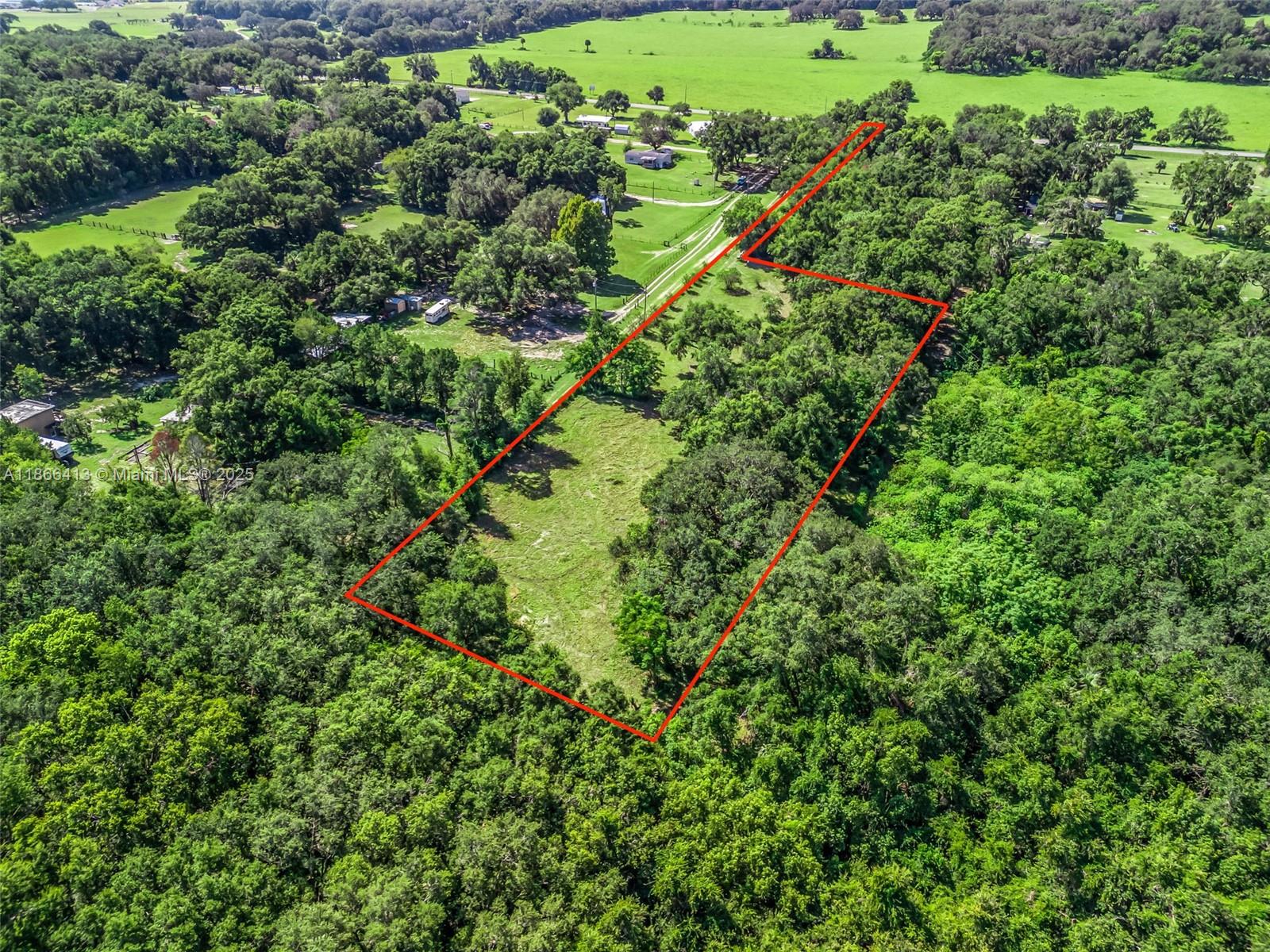Welcome to 12751 SE Highway 42 in the heart of Weirsdale, Florida—an exceptional opportunity to own a piece of timeless Old Florida charm. Tucked down a private drive and shaded by majestic 100-year-old oaks, this tranquil property offers natural beauty, privacy, and endless possibilities. With well, septic, and electric in place, it’s ready for your vision—whether you're building a dream home, creating a multigenerational compound, or investing in future development. Eligible for a minor lot split, the land allows for multiple homesites and is conveniently located just minutes from the water. Properties with this much character, flexibility, and potential in such a peaceful setting are rare. A must-see for those seeking space, serenity, and opportunity in Marion County.