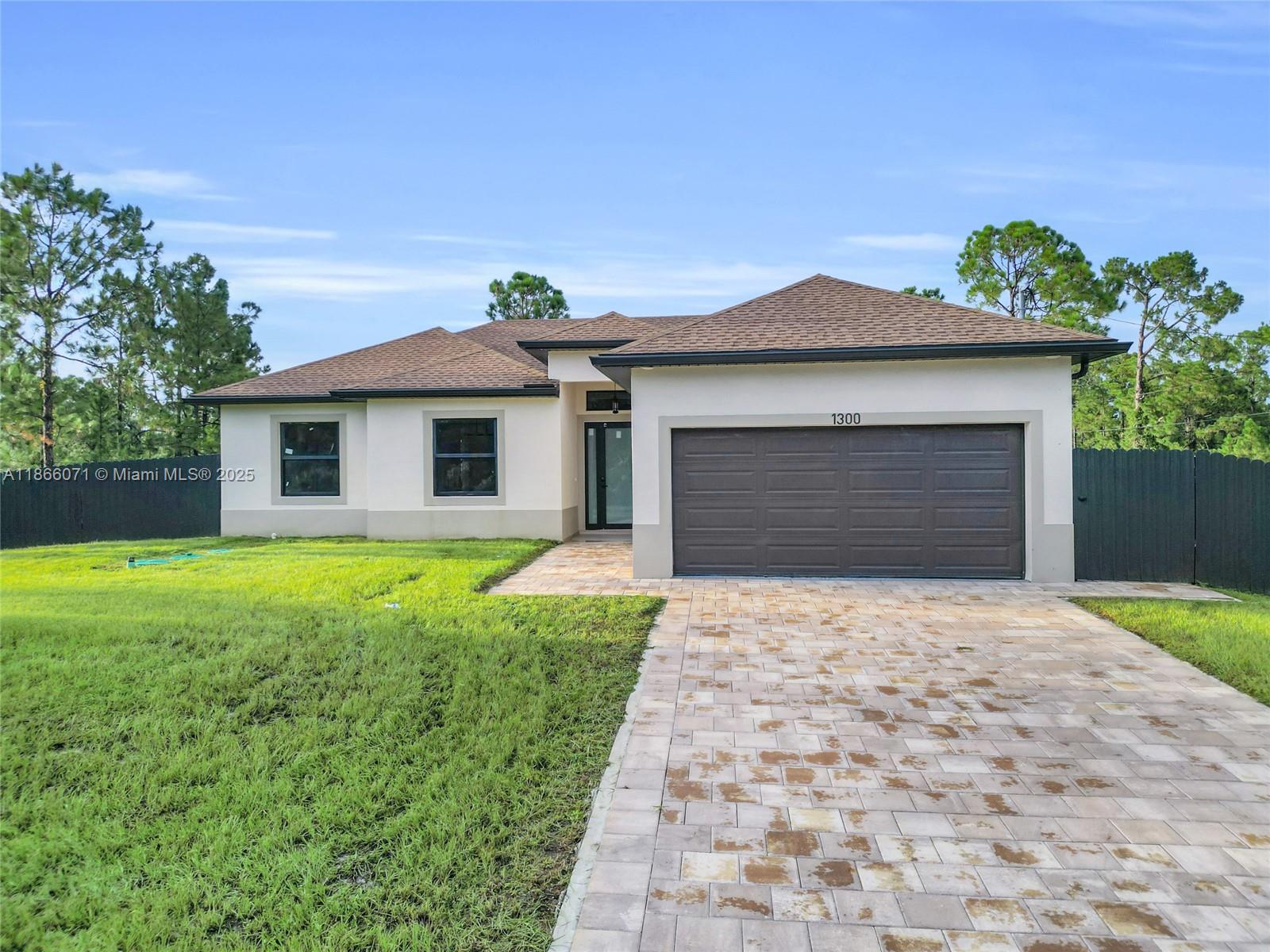 This 2025 new construction home sits on a desirable corner lot in a no-flood zone and includes a recent transferable appraisal at $370,000. Featuring 3 bedrooms, 2 baths, and a bright split-bedroom layout with impact-resistant windows and doors, it offers a chef’s kitchen with quartz countertops, stainless steel appliances, custom cabinetry, and a versatile island with built-in desk space. The primary suite includes two walk-in closets, dual sinks, and a luxury shower with crystal glass doors. Additional highlights include a fenced yard, covered lanai with ceiling fan, laundry room with sink, and a complete water filtration system. The lot directly behind the property is also available for sale, providing the opportunity to expand, build, or secure additional land.