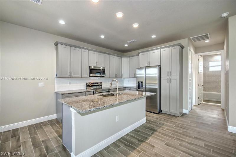 New construction in Lehigh Acres! Modern 3-bedroom, 2-bath home with 1500 sq ft of living space. Open floor plan, high ceilings, and contemporary finishes. Gourmet kitchen with stainless steel appliances and quartz countertops. Spacious master suite with walk-in closet and private bath. Large backyard perfect for entertaining or future pool. Located in a quiet, fast-growing area. Home will be ready in approximately 2 months—don't miss this opportunity!