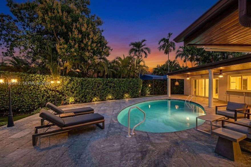 NEW PRICE! A truly rare offering in one of the most coveted pockets of North Miami Shores—this exceptional residence has been tightly held for over three decades & is now available for the most discerning buyer! Thoughtfully reimagined with a refined eye for design and livability, the home spans over 3,200 total SFT, offering four bedrooms and three impeccably appointed bathrooms. A seamless, open-concept layout anchors the residence, centered around an Italian-inspired chef’s kitchen featuring bespoke cabinetry, a generous island, pristine white quartz surfaces, top-tier appliances, and a gas range. Overlooking the living spaces, a resort-style Diamond Brite pool is framed by lush, mature landscaping, creating a private sanctuary / Zen-like ambiance. A covered patio and gazebo set the stage for sophisticated gatherings. A split-bedroom floor plan with soaring ceilings and recessed lighting elevate the home’s airy, modern aesthetic. Extensive capital improvements—exceeding $250,000—offer peace of mind and effortless ownership, including a newer roof (2015), plumbing (2018), electrical panel (2017), central A/C (2019), & pool with equipment (2022). Additional mini-split systems (2025) provide tailored climate control throughout. The property is further enhanced by full impact windows & doors, a spacious circular driveway, & a one-car garage or possible fifth bedroom, private office, or studio. This exceptional, once-in-a-generation opportunity, is waiting for your family!!