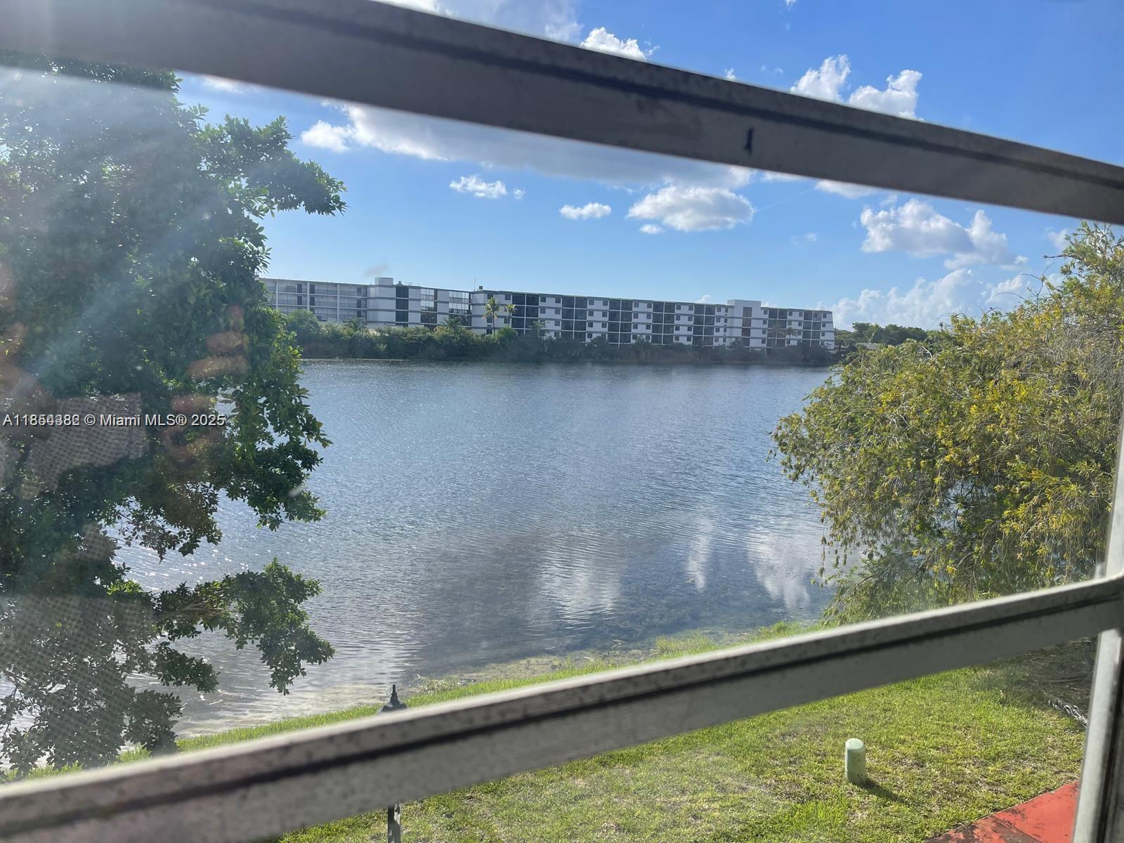 Beautiful and spacious 1 bed, 1.5 bath apartment with den, private garage, and guest parking in the desirable Skylake community. Located on the 2nd floor, this well-maintained unit features stunning lake views, bright open-concept living and dining areas, an updated kitchen with modern appliances and ample cabinetry, and generous closet space. The den with panoramic lake view is perfect for a home office, reading nook, or guest space. Enjoy your morning coffee on the private balcony surrounded by nature and tranquility. The community offers manicured landscaping, walking paths, and gated access. Washer and dryer on-site. Ideally located near shopping, dining, Walmart, Aventura Mall, major highways, top-rated schools, and just minutes from the beach. Ready for immediate move-in.