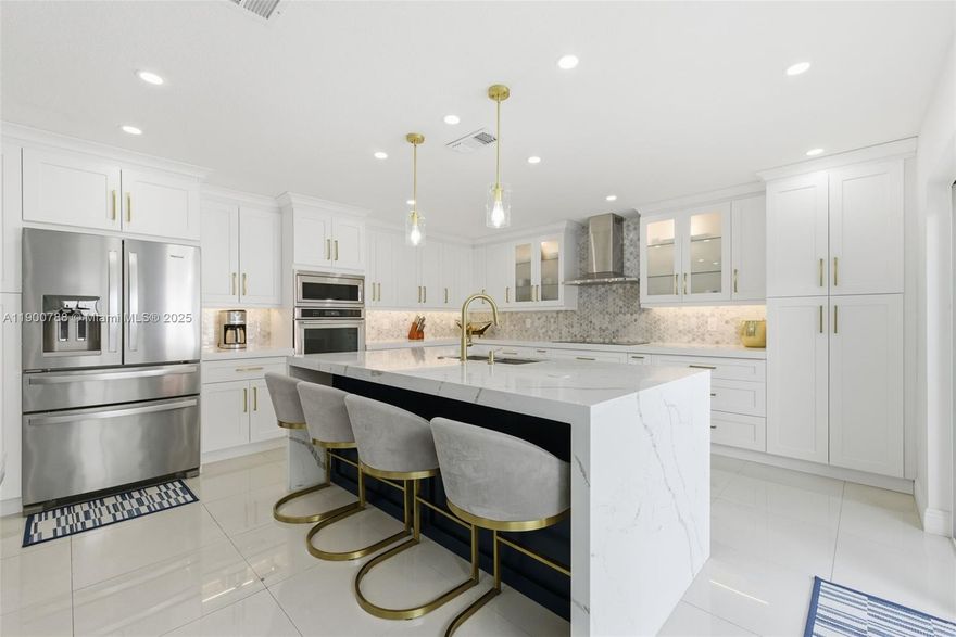 A rare and stunning, fully renovated townhouse in The Hammocks, West Kendall. This spacious 1,790 sq. ft. home offers five bedrooms, with the fifth created from a converted garage featuring a kitchenette and laundry area. Enjoy two elegant full baths and a guest bath, all with modern finishes. Every detail was reimagined with new flooring, a designer kitchen, and stylish fixtures throughout. Hurricane impact windows and doors provide peace of mind, complemented by a new roof and an HOA that covers the exterior and roof for lower insurance costs. The community maintains strong reserves, qualifies for 3% down financing, and offers resort-style amenities with lakefront trails, pools, tennis courts, lush parks, and nearby Publix and The Hammocks Town Center, just a 4-minute drive away.