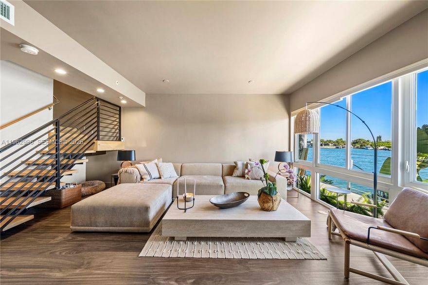 One-of-a-kind four-story waterfront townhome in the exclusive Iris on the Bay in Miami Beach, offering refined modern luxury and open bay views from every level. Built in 2015, this 4-bedroom, 4.5-bath residence showcases fully updated, designer-appointed finishes throughout, including wide-plank oak wood floors, custom lighting, and European-style kitchen with premium appliances, gas range, marble countertops, and sleek cabinetry. Four spacious en-suite bedrooms feature spa-inspired baths, walk-in closets, and private balconies. A private elevator leads to a spectacular rooftop terrace with a built-in gas outdoor kitchen and breathtaking bay views. Additional highlights include a full-home water filtration system, integrated Sonos sound system, smart home technology, electric vehicle charger, impact windows and doors, full-size laundry, and a temperature-controlled 2-car garage. Located in a gated waterfront community with pool, just minutes from the beach, Bal Harbour, fine dining, and shopping — A MUST SEE!