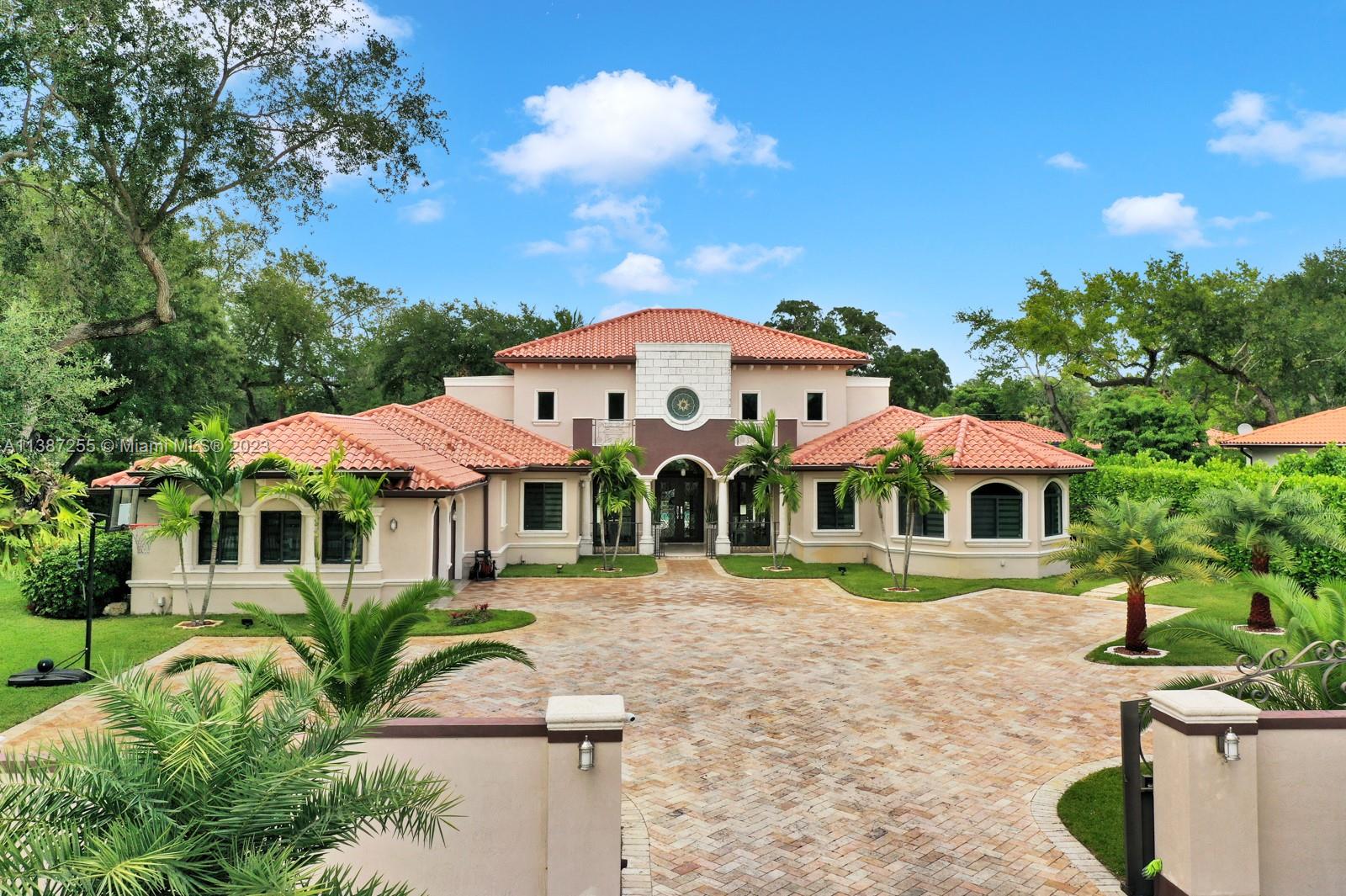 This custom-built 4 bed, 6 bath home is situated on a corner lot spanning over 27,000 sq ft. With over 5,000 sq ft of living space, this home offers beautiful marble floors, high ceilings, and impact windows throughout. The custom kitchen features two built-in fridges and the bedrooms are spacious and inviting. The entertainers dream backyard includes a built-in outdoor covered kitchen. The side gate entrance and massive driveway provide ample parking. Luxury living awaits in this one-of-a-kind home.