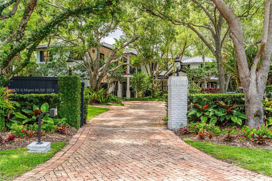 Located on a tranquil, tree-lined street in Pinecrest, this impressive gated home features 8 bedrooms and 6 bathrooms on a 40,336 square foot lot. The welcoming entry leads to a spacious 10,694 square foot interior with soaring ceilings. The eat-in kitchen, with top-of-the-line appliances and a large island, flows into the family room. The formal dining room includes a custom temperature-controlled 2,000-bottle wine cellar. The primary bedroom offers walk-in closets and a private balcony with stunning backyard views.
Outdoor amenities include a pool, outdoor kitchen, gazebo , basketball court, and putting green. Other Highlights  are metal roof, guest quarters, a generator, and a 2-car garage. Don't miss out on this amazing property.