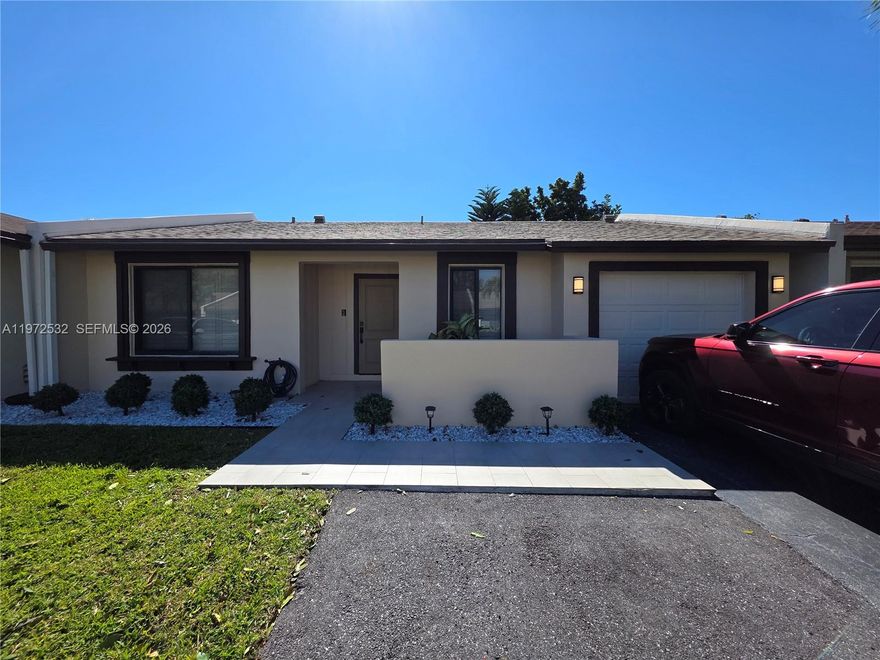 Welcome to this exceptionally renovated 2bed/2bath/1cg villa in the 55+ Las Verdes community in Delray Beach. No expense has been spared here! Enclosed porch (currently a family room) adds approx. 170sqft to the livable square footage. Thoughtful & valuable improvements done in the last 2 years: new shingle roof (2025), complete hurricane impact windows/front door/garage door (2024), tankless WH (2025), GORGEOUS new kitchen with quartz counters & stainless-steel LG appliances (2024-25), all new plumbing (2025 - installed in attic for easier access, leak detection & to avoid any potential slab issues), 32x32' tile throughout all living areas & bedrooms, both bathrooms fully updated, walk-in shower & smart toilet in guest bath, newer interior paint & baseboards, plantation blinds throughout, new interior doors, full-size washer/dryer inside garage & driveway expanded to fit 2nd vehicle. Volume ceilings, recessed LED lighting & ample windows really showcase the beauty of this home. Enjoy the lovely shady tiled patio that overlooks a common area green space. AC unit is dated 2022. Las Verdes is a well-maintained gated community that emulates "pride of ownership" & boasts plentiful amenities including a clubhouse, 3 pools, fitness room, lighted tennis/pickleball courts, billiard room, library, shuffleboard & bocce courts & winding scenic walking paths. Minutes from the FL Turnpike, I-95, hospitals, retail, dining & less than 5 miles from the beach. Come take a tour & fall in love!