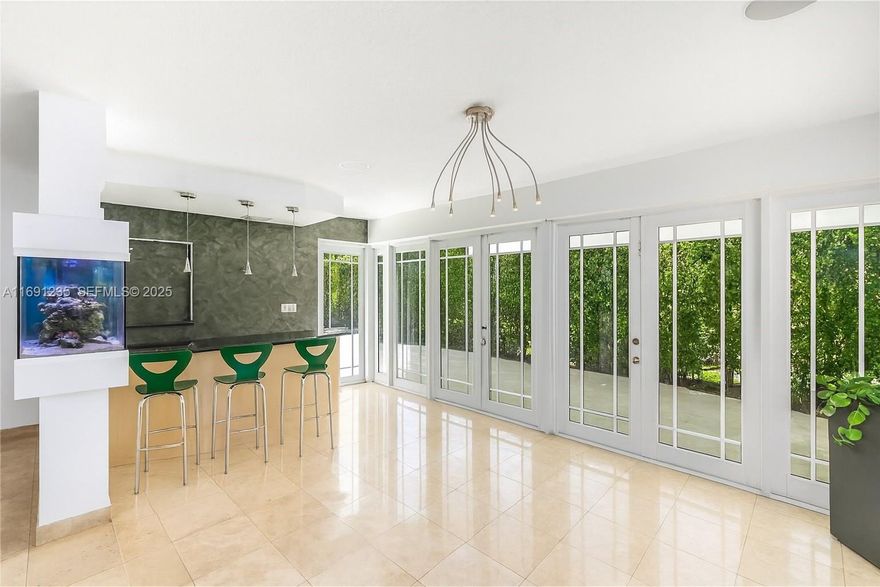 Exceptional corner home in Surfside, located just in front of multi-million-dollar waterfront estates and within walking distance to the beach. Set on a desirable oversized corner lot, this residence offers more space and privacy than typical neighborhood homes. The beautifully maintained and partially remodeled 3/2 features a bright Florida Room filled with natural light, plus a fully equipped kitchen with an open pass-through to the dining area. A thoughtful layout places all bedrooms and bathrooms in a private, separate wing for added tranquility. The spacious garage provides rare potential, with plumbing for a bathroom and laundry room and a separate side entry—ideal for converting into an office, guest suite, or extra bedroom. Outdoors, enjoy a sparkling pool, soothing Jacuzzi, summer kitchen, and a large covered terrace perfect for relaxing or entertaining. With a 2019 roof and quality upgrades throughout, this home combines comfort, style, and prime location. Strong appreciation, high rental demand, and limited inventory also make it an excellent investment with solid long-term ROI potential.