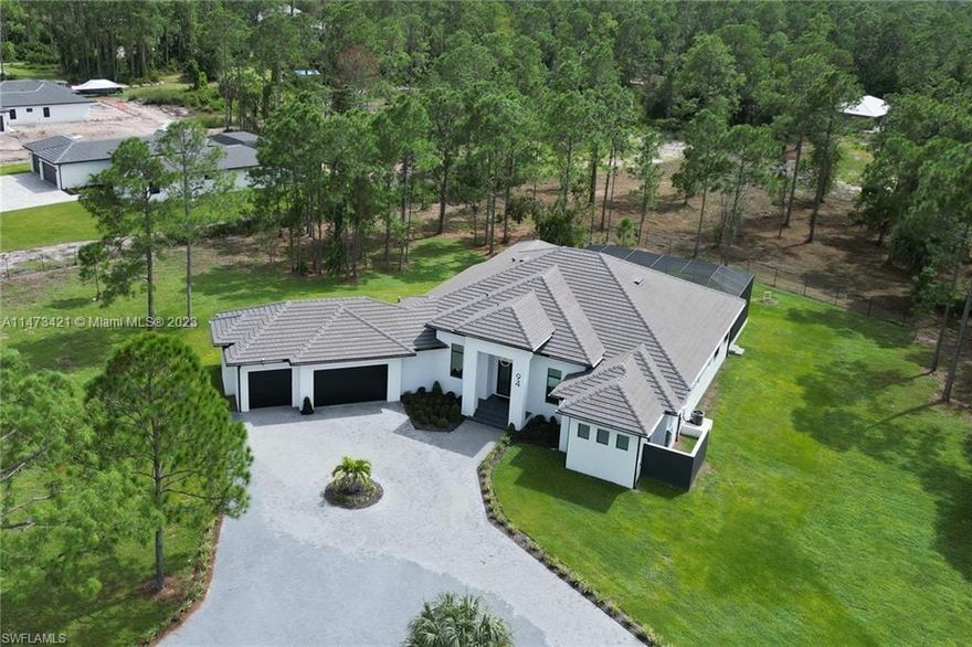 Introducing the magnificent "IDENTITY Model" by Affinity Homes! This opulent residence showcases an extraordinary 4ft STEM WALL and boasts 4 bedrooms plus a den, accompanied by 4 and a half bathrooms. Enveloped by 2.76 acres of flourishing vegetation! Step into the spacious and luminous interiors, adorned with stunning porcelain tile flooring that seamlessly flows throughout the main living spaces. The culinary enthusiast will be captivated by the sublime gourmet kitchen, equipped with top-of-the-line stainless steel appliances, a pot filler, and an expansive kitchen island complete with a wine cooler and walk-in pantry. Additionally, your beloved furry companions will be pampered with a luxurious pet shower!