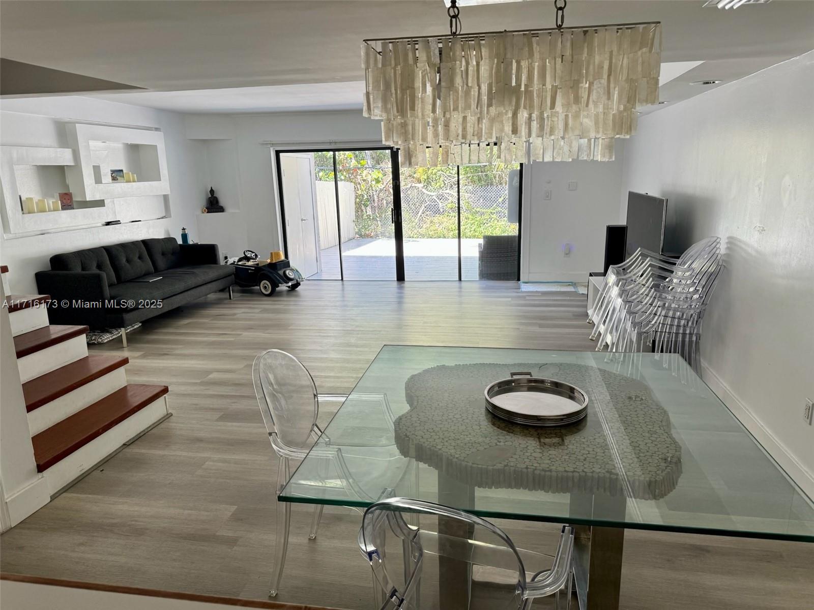 This beautiful townhome comes with Three bedrooms, Two bathrooms upstairs with wood and laminate flooring, in downstairs 1/2 bath. Kitchen opens to very spacious living and dining room. Large patio with views of tree park area. Two assigned parking spaces, and guest parking nearby. The condominium comes with a pool! Smart Home Finger Print Access, Alarm, and Cameras (everything controlled by phone). Air conditioning has been replaced not too long ago. Just a couple of blocks away you have Shopping center, Just over the bridge you have the beaches of Sunny Isles.